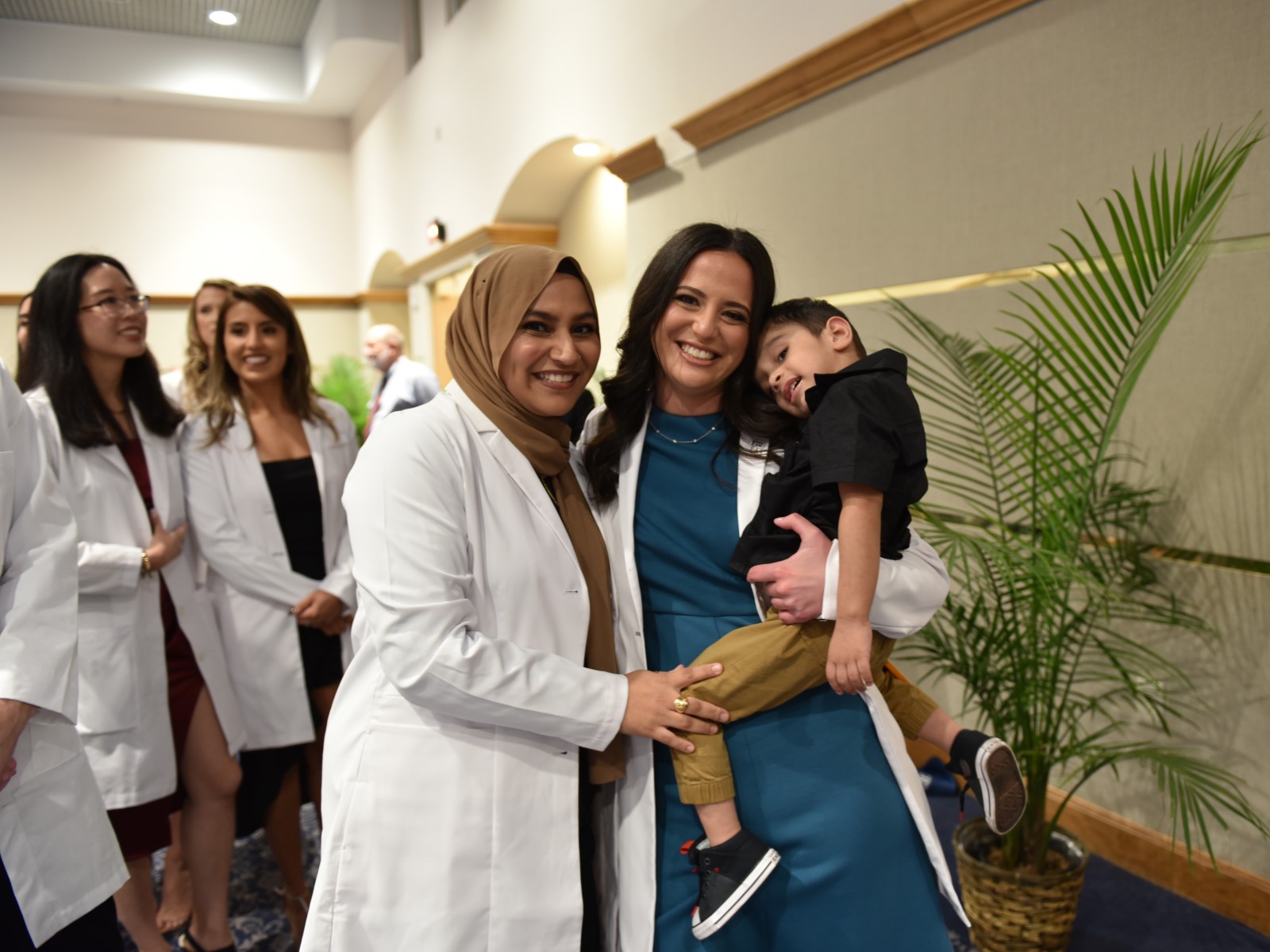 Two FIU MPAS graduates at their white coat ceremony