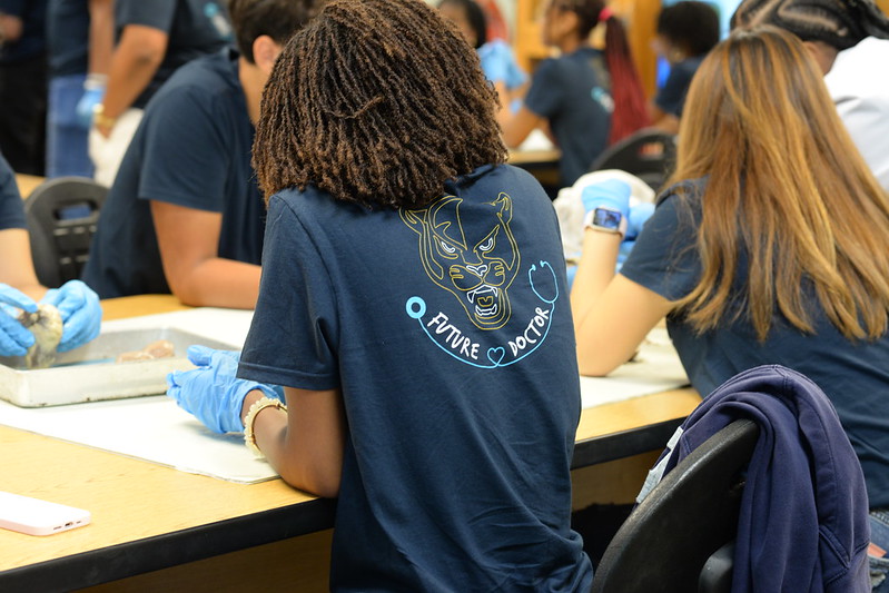 FIU Junior Doctors of Tomorrow examining mannequin ear