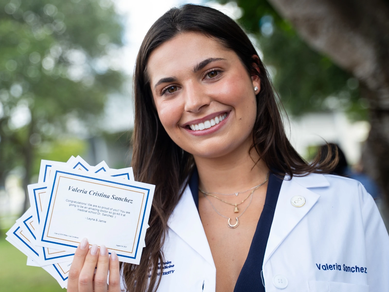 Medical student Valeria Sanchez showing the camera her donor message at the Class of 2029 White Coat Ceremony.