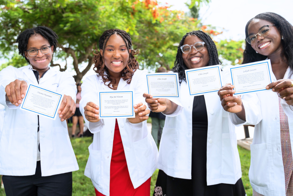 Med students holding note found in their white coat pockets