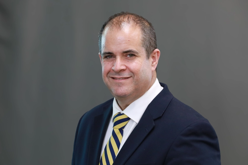 Osmel "Ozzie" Delgado professional headshot.