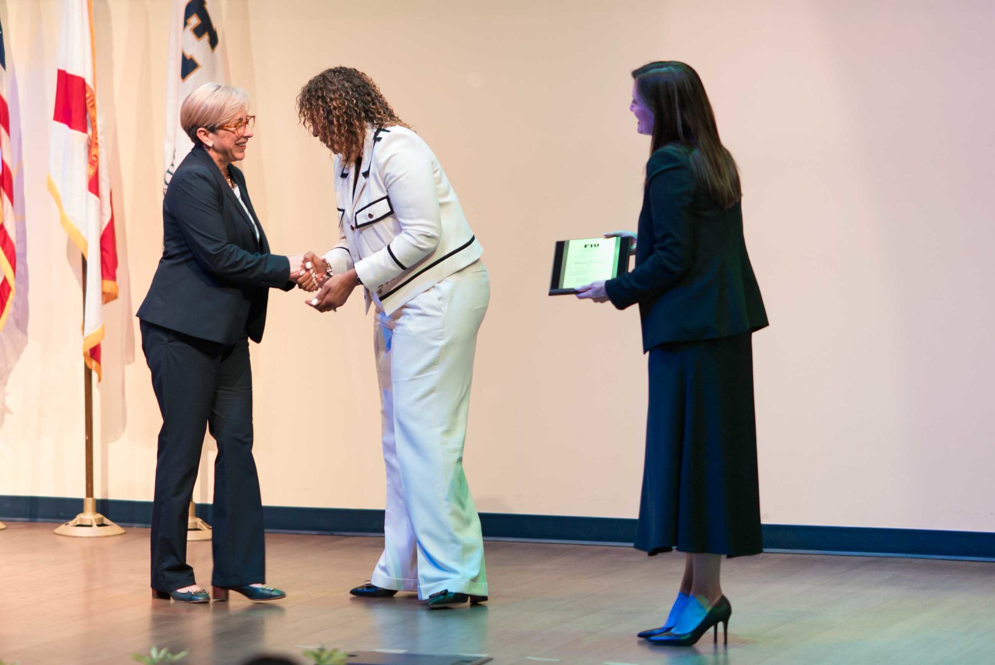 Patricia Junquera, M.D., receives award on stage.