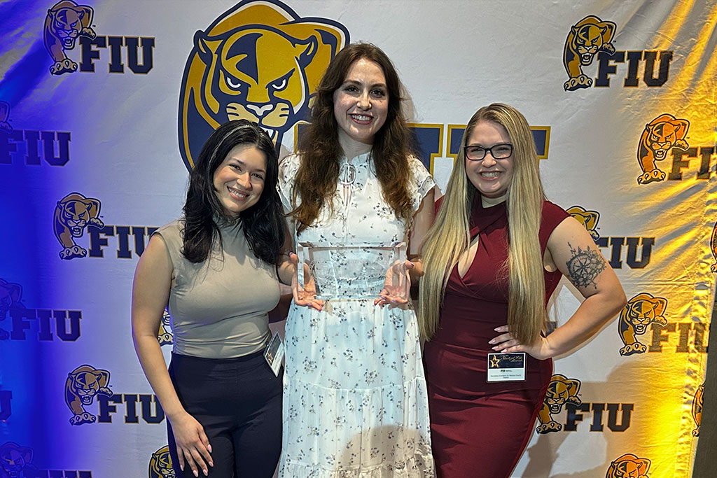 (From left) Medical students Ashley Moscoso, Rachel Siretskiy, and Mikahla Gay accept the FIU Outstanding Service Award on behalf of the student-led initiative FIU HOME at this year’s FIU Outstanding Student Life Awards ceremony.